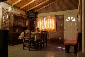 a kitchen with a table and chairs and a white door at BelloLugar in San Rafael