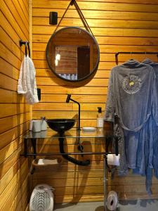 a bathroom with a sink and a mirror at Cabanas nascer do sol - Encantada in Barracão