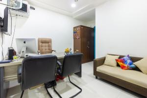 an office with a desk and a couch at Hotel O Qualia Inn Kondapur Near Botanical Garden in Hyderabad