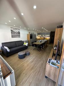 a living room with a couch and a table at FeWo 236 Aparthotel Mittelberg in Mittelberg