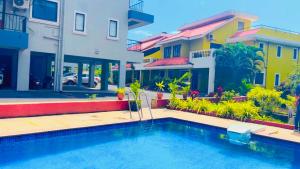 a swimming pool in front of some buildings at 3 bhk home stay baga in Arpora