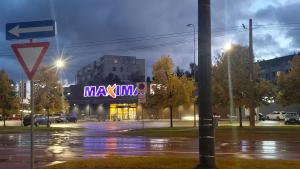a building with a large neon sign on it at JOJO Loft Comfort Dzelzavas & Cozy Stay & Breakfast Gift in Riga