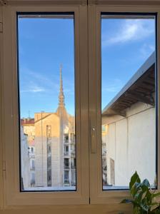 a window with a view of a building at Little House Amedeo in Turin +13 photos