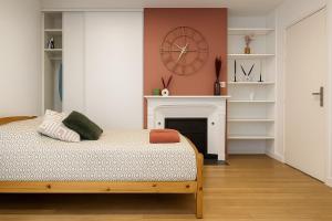 a bedroom with a bed with a fireplace and a clock at Casa Terracotta 2 people -Central in Mâcon