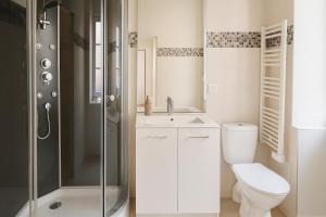 a bathroom with a toilet and a sink and a shower at Casa Terracotta 2 people -Central in Mâcon