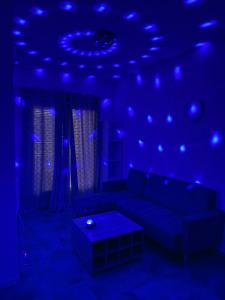 a blue room with a couch and a table at Flandre 01 in Roubaix