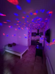 a room with purple and blue lights on the ceiling at Flandre 01 in Roubaix