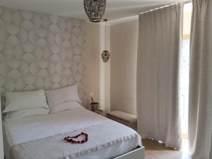 a bedroom with a bed and a large window at B&B San Pancrazio hotelHouse in Catania