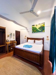 a bedroom with a bed and a dining room at Pajevista villa in Paje