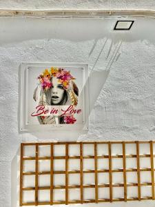 a picture of a woman with flowers on a wall at Sol y Mar Apartments in Calpe