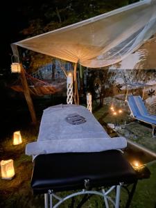a bed under a tent with two chairs under it at Villa Kampou in Leptokarya