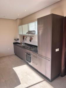 a kitchen with a large stainless steel refrigerator at Appart For Rent Kech in Marrakech