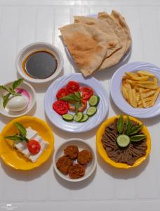 a table with different plates of food on it at Gagal House in Siwa