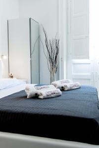 a bedroom with a bed with two pillows on it at L'Opera Buffa in Palermo