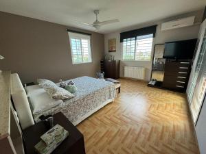 Un dormitorio con una cama y un televisor de pantalla plana. en Villa Loli, Quiet villa with pool, next to beach and city, en Grao de Castellón 33 fotos más