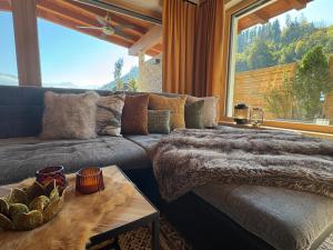 a living room with a couch and a large window at Apartment ZillerSoul in Uderns