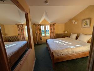a bedroom with a large bed and a window at Auberge Des Chasseurs in Échenevex