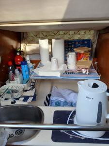 a kitchen with a sink and a shelf with toiletries at Sem Gritos in Lisbon