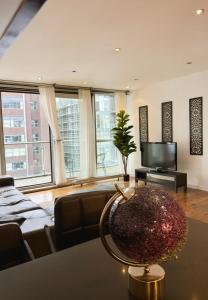 a living room with a couch and a television at Lowry River Twin Balcony Deluxe in Manchester