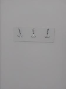 two hooks on a shelf in a bathroom at Rooms By the way M17 in Vrapčići