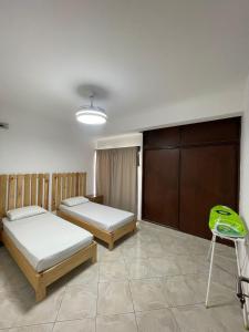 a bedroom with two beds and a chair in it at Casa Morabeza in Santa Maria