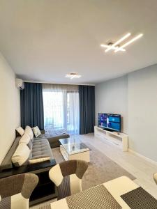 a living room with a couch and a television at Central Home with Underground Parking in Varna City