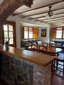 a dining room and living room with a stone counter at RuralRusticHome in Altura