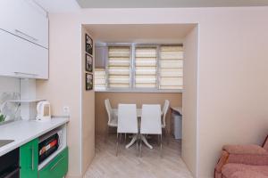 a kitchen and dining room with a table and chairs at Harkovskaya 37 in Sumy +2 photos