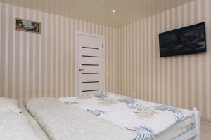 a bedroom with a bed and a small cabinet at Harkovskaya 37 in Sumy