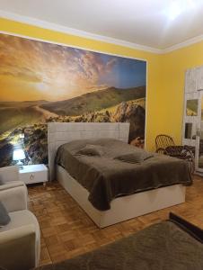 a bedroom with a large painting on the wall at Gamsakhurdia Street in Borjomi