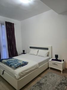 a bedroom with a white bed and a window at Flat Rafailovic One minute to Beach in Budva +45 photos