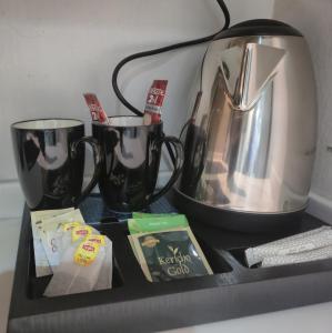 a counter with a coffee maker and two cups at نوارة المزاحمية in Riyadh