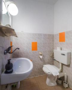 a bathroom with a white toilet and a sink at Breezot Yam in Nahariyya