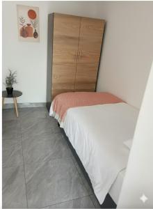 a small bedroom with a bed and a dresser at 60 On Kosmos in Bellville South