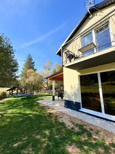 a house with a horse in the background at Villa Marija in Livno