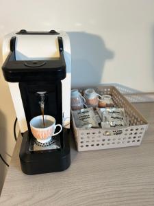 a coffee maker sitting next to a box of cupcakes at Viale Apartment in Isola del Liri