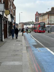 a red double decker bus on a city street at Jerryinn Rooms in London