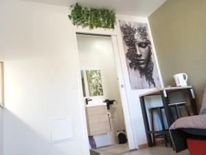 a room with a door with paintings on the wall at Studio in Moussac +1 photo