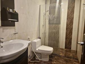 a bathroom with a sink and a toilet and a shower at شركة نيروز ان للشقق المخدومه in Jeddah