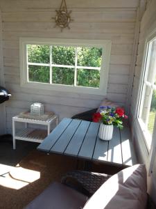 a picnic table in a room with a window at Furusol Borgholm in Borgholm +1 photo