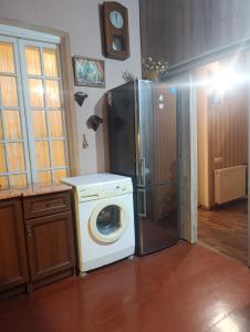 a kitchen with a washing machine and a refrigerator at Gamsakhurdia Street in Borjomi