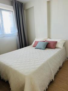 a bed with two pillows on it in a bedroom at Alma de Mar in Finestrat +17 photos