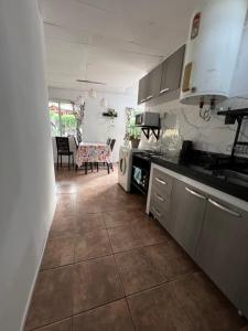 a kitchen with a tile floor and a counter top at La casita the Aye in Villa Carlos Paz +17 photos
