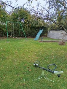 a park with a seesaw and a playground at Gîte des pins 1 et 2 personnes in Saint-Martin-au-Bosc