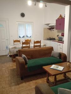 a living room with a couch and a table at Gîte des pins 1 et 2 personnes in Saint-Martin-au-Bosc