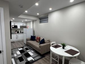 a living room with a couch and a table at Oxnard Villa in Winnipeg