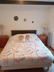 a bedroom with a bed with two pillows on it at Gîte des pins 1 et 2 personnes in Saint-Martin-au-Bosc
