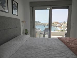 a bedroom with a bed and a view of the ocean at Apartment with stunning views of Bahia Hornillo & Pool - Aguilas in Águilas +29 photos