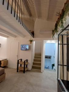 a living room with stairs and a stair case at La Dimora di Zia AR in San Giovanni Rotondo
