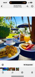 a picture of a table with food and drinks at Pousada Luar da Praia in Imbassai